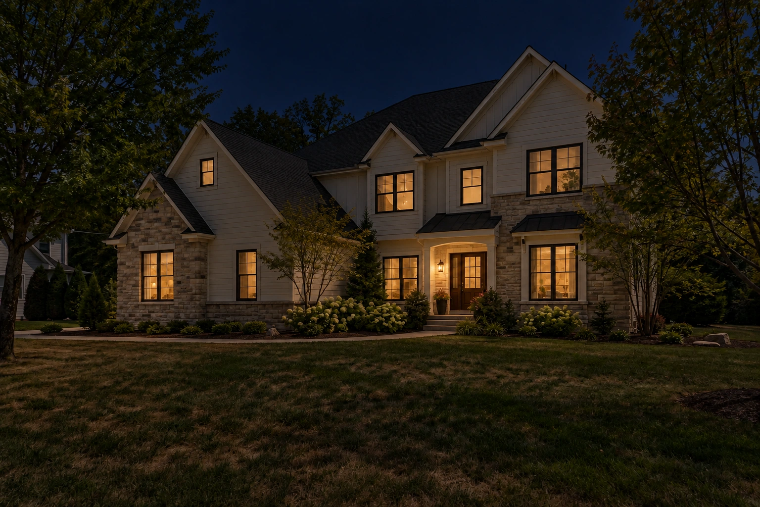 The house at night with dark sky and illuminated windows